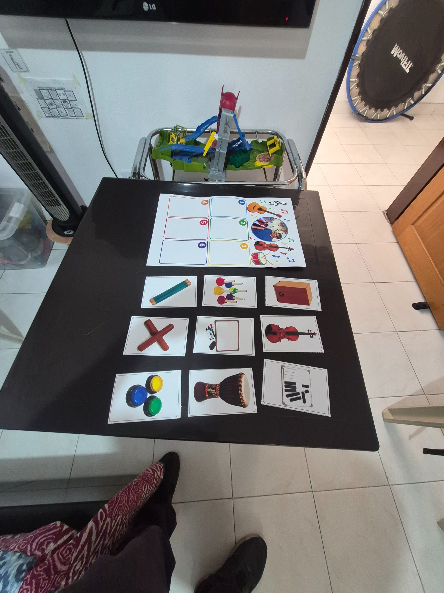 Agenda impresa de mesa con seis espacios numerados y tarjetas de instrumentos y actividades; al fondo se observa una agenda de pared.